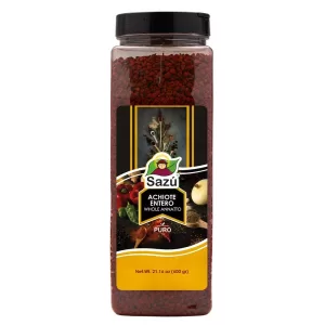 Achiote Entero Sazú 600 gr en tarro dosificador, condimento natural ideal para colorear y sazonar arroces, carnes, sopas y platos tradicionales.